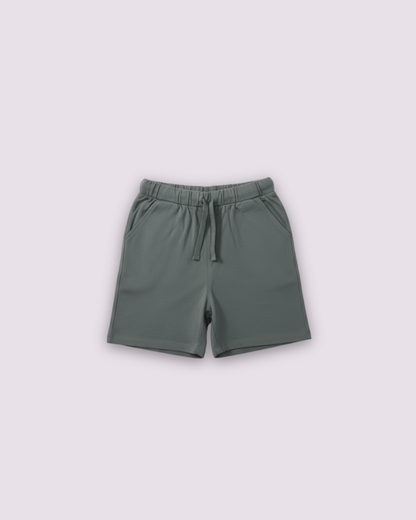 Soft olive green kids jersey cotton shorts with elastic waistband and drawstring detail