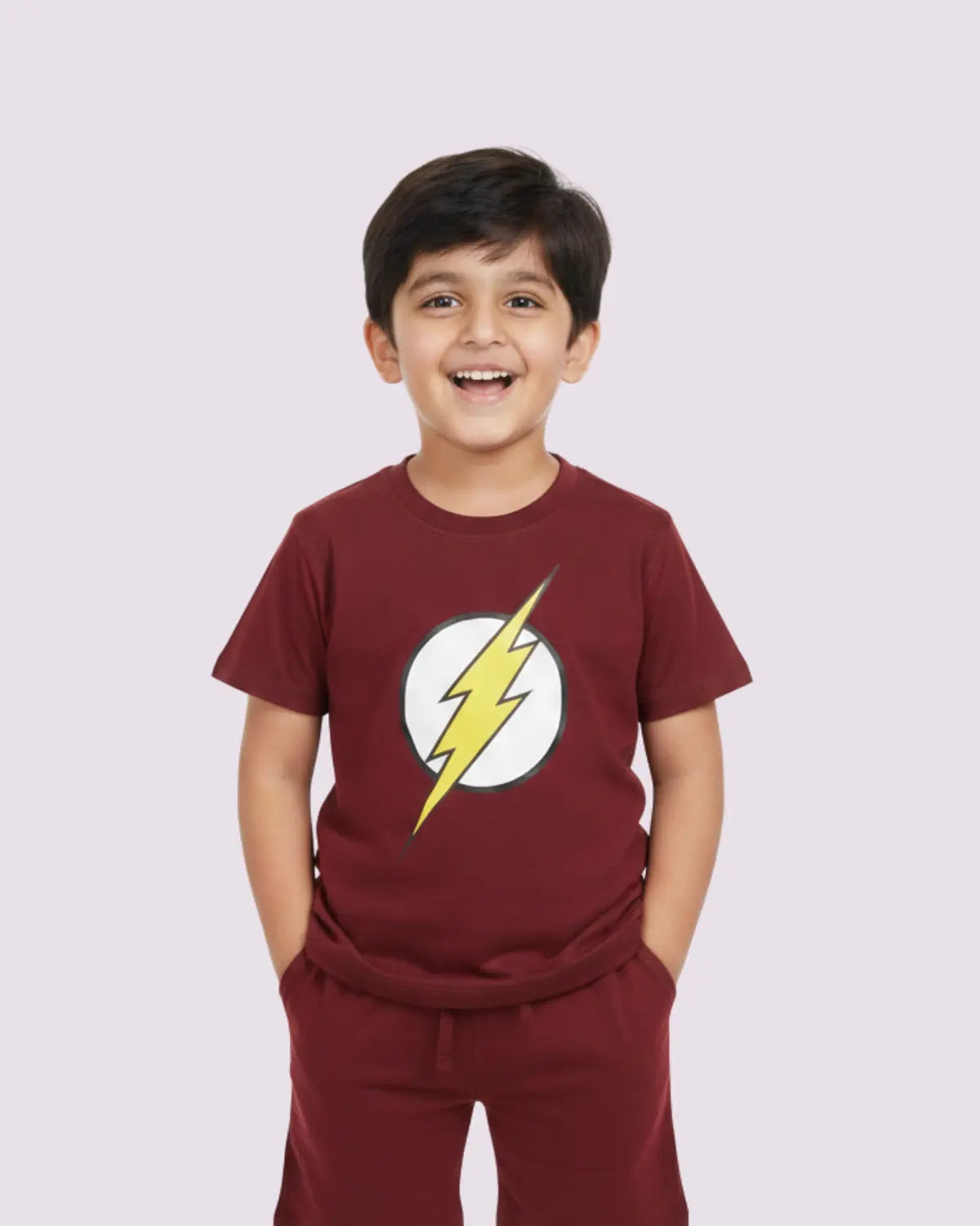 Child wearing a maroon t-shirt with a lightning bolt design