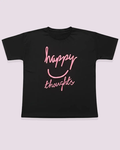 Black t-shirt with pink 'happy thoughts' text on a light gray background
